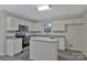 Modern kitchen with white cabinets, granite countertops, and stainless steel appliances at 808 Plateau Ct, Rock Hill, SC 29730