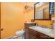 Small bathroom with dark brown vanity and yellow walls at 8214 Addison Dr, Harrisburg, NC 28075