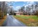 Brick home with a long driveway and basketball hoop at 8214 Addison Dr, Harrisburg, NC 28075