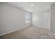 Spacious bedroom featuring carpet, window with blinds, and neutral walls at 8216 Stonemere Ln, Charlotte, NC 28215