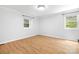 Bright bedroom featuring light wood laminate flooring and two windows at 107 Grand Canyon Rd, Stanley, NC 28164