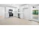 Kitchen with white cabinets, stainless steel appliances, and access to sunroom at 107 Grand Canyon Rd, Stanley, NC 28164