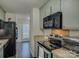 Modern kitchen with stainless steel appliances and light green cabinets at 11324 Kingfisher Dr, Charlotte, NC 28226