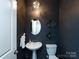 Modern powder room with dark walls and updated fixtures at 15533 Capps Rd, Charlotte, NC 28278