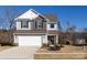 Two-story house with gray and brown siding, white garage door, and landscaping at 15533 Capps Rd, Charlotte, NC 28278