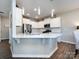 Modern kitchen with white cabinets and a large island at 15533 Capps Rd, Charlotte, NC 28278