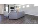 Living room with hardwood floors, sectional sofa, and fireplace at 15533 Capps Rd, Charlotte, NC 28278