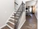 Elegant staircase with dark wood and wrought iron railing at 15533 Capps Rd, Charlotte, NC 28278