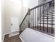 Elegant staircase with dark wood and wrought iron railing at 15533 Capps Rd, Charlotte, NC 28278