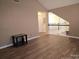 Upstairs hallway with wood flooring and access to bedrooms at 16039 Lavenham Rd, Huntersville, NC 28078