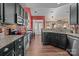 Open kitchen with granite countertops, stainless steel appliances, and dark cabinets at 16039 Lavenham Rd, Huntersville, NC 28078