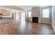 Open living space with hardwood floors, a fireplace, and kitchen access at 2529 Crimson Way, Monroe, NC 28112