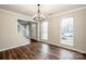 Bright dining room with hardwood floors, chandelier, and view of staircase at 316 Reed Creek Rd, Mooresville, NC 28117