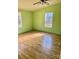 Bright bedroom featuring wood-look floors and a ceiling fan at 6957 Ray Linker Rd, Concord, NC 28025