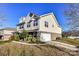 Side view of a two-story house with brick and vinyl siding, showcasing the garage at 7534 April Mist Trl, Huntersville, NC 28078