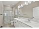 Double vanity bathroom with a large mirror and glass shower at 8205 Stonemere Ln, Charlotte, NC 28215