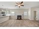 Living room with hardwood floors, fireplace, and access to kitchen and dining area at 8205 Stonemere Ln, Charlotte, NC 28215