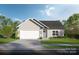Modern house exterior with a two-car garage and landscaped lawn at Lot 12 Contentment Ct, Kannapolis, NC 28081