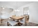 Dining room table with four chairs and a view into the kitchen at 107 Meadowcreek Village Dr, Locust, NC 28097