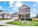 Attractive two-story home with a two-car garage, neat landscaping, and holiday wreath on door at 107 Meadowcreek Village Dr, Locust, NC 28097