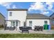 Back exterior of house featuring a patio with dining area and grill at 107 Meadowcreek Village Dr, Locust, NC 28097