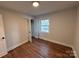 Empty bedroom with hardwood floors, closet, and single window at 1327 Marble St, Charlotte, NC 28208