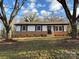 Brick ranch house with white siding, updated landscaping, and a spacious yard at 1327 Marble St, Charlotte, NC 28208