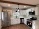 Modern kitchen with white cabinets, stainless steel appliances, and a farmhouse sink at 1327 Marble St, Charlotte, NC 28208