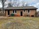 Brick home with a back yard and access door at 1327 Marble St, Charlotte, NC 28208