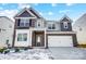 Two-story brick home with a large white garage door and landscaping at 206 Abersham Dr, Mooresville, NC 28115