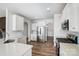 Modern kitchen with white cabinets, stainless steel appliances, and quartz countertops at 206 Abersham Dr, Mooresville, NC 28115