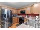 Kitchen features stainless appliances, wood cabinetry, and a red accent wall at 244 Whisper Dr, China Grove, NC 28023