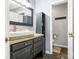 Modern bathroom with dark vanity, large mirror, and separate toilet area at 2711 Rozzelles Landing Dr, Charlotte, NC 28214