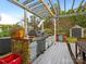 Outdoor kitchen with grill, bar and pergola at 2711 Rozzelles Landing Dr, Charlotte, NC 28214