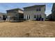 Rear view of the two-story home with backyard and trampoline at 3033 Eastcott Ave, Monroe, NC 28110