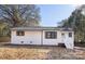 Updated white brick ranch home with dark gray roof and shutters at 3314 Maywood Dr, Charlotte, NC 28205