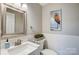 Updated bathroom with white vanity, modern fixtures, and gray tile flooring at 3795 Deer Run, Denver, NC 28037