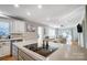 Kitchen with island, cooktop, and view into adjacent dining area at 3795 Deer Run, Denver, NC 28037