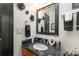 Modern bathroom with dark vanity, granite countertop, and black accents at 4042 Cindy Woods Ln, Charlotte, NC 28216