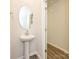 Simple bathroom with pedestal sink and a linen closet at 5033 Kellaher Pl, Charlotte, NC 28216