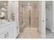 Modern bathroom with a large walk-in shower, double vanity, and white cabinets at 5037 Kellaher Pl, Charlotte, NC 28216