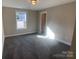 Bright bedroom with neutral carpeting and large closet at 511 E Sycamore St, Lincolnton, NC 28092