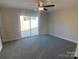 Bright bedroom with carpet flooring and sliding glass door leading to backyard at 511 E Sycamore St, Lincolnton, NC 28092