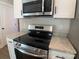 Stainless steel microwave and rangetop in kitchen at 511 E Sycamore St, Lincolnton, NC 28092