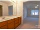 Bathroom with wood vanity, single sink and view into bedroom at 622 Court Side Dr, Salisbury, NC 28147