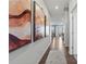 Bright hallway with hardwood floors and modern wall art leading to the living area at 716 Hallman Branch Ln, Lincolnton, NC 28092