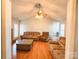 Living room with vaulted ceiling, fireplace and brown couches at 907 Edgehill Dr, Monroe, NC 28110