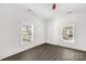 Bright bedroom with two windows, dark gray floors and ceiling fan at 102 Oakland St, Clover, SC 29710