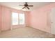 Spacious bedroom with two windows, ceiling fan, and pink walls at 1122 Oak Alley Dr, Indian Trail, NC 28079