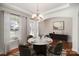 Bright dining room features a table for four and chandelier at 13919 Highland Meadow Rd, Charlotte, NC 28273